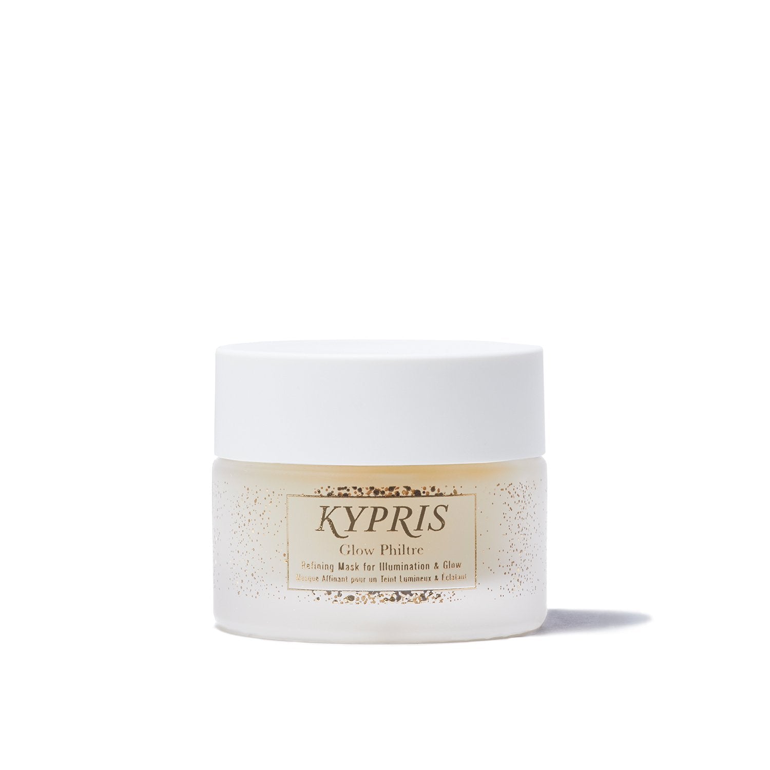 Glow Philtre Mask, in frosted glass jar showing translucent yellow gold color of mask, for the appearance of soft, glowing skin.