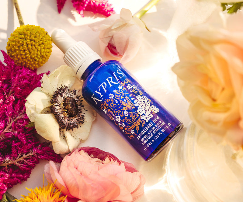 KYPRIS Antioxidant Dew Serum with floral accents, organic botanicals, and vibrant flowers