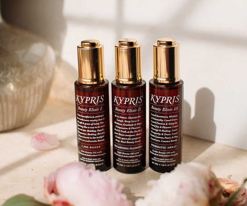 KYPRIS Beauty Elixir I, II, III bottles with gold caps and floral accents