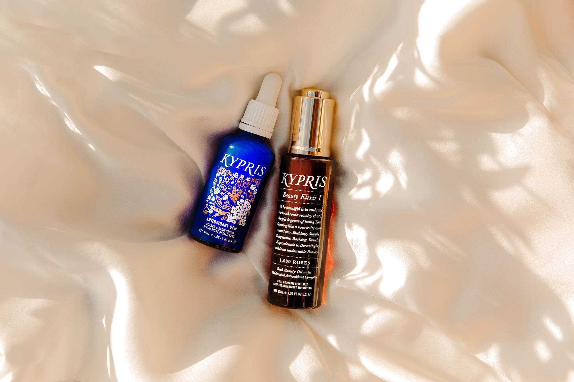 KYPRIS Antioxidant Dew & Beauty Elixir I serums on silk with dappled light, 47mL each