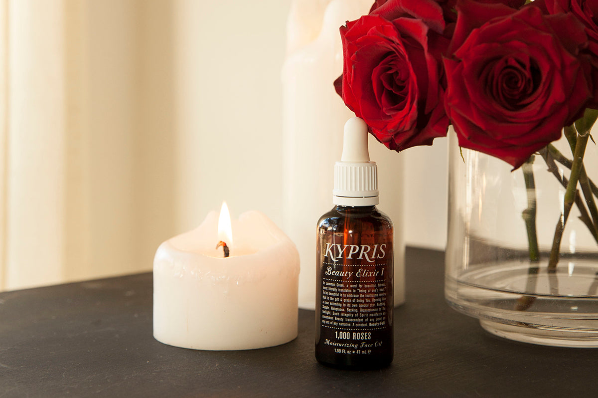 KYPRIS Beauty Elixir I 1,000 Roses Moisturizing Face Oil with lit candle and red roses