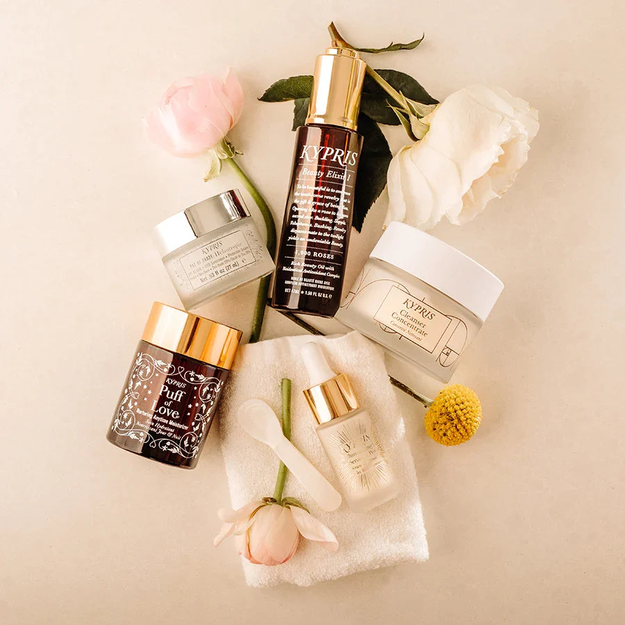 KYPRIS Beauty Elixir, Puff of Love, Cleanser Concentrate, and serum with roses and towel
