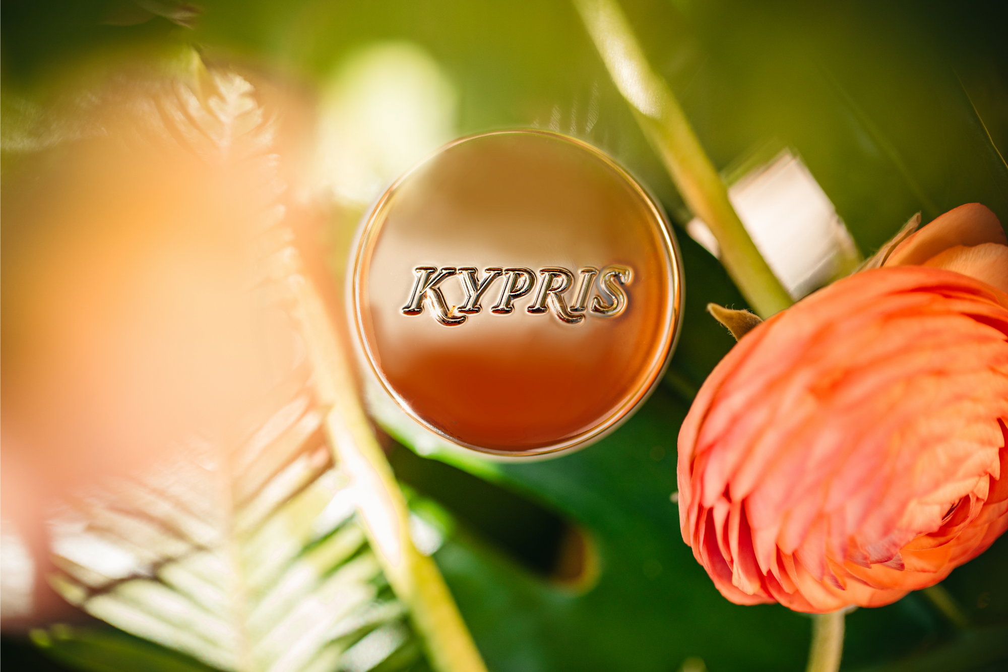 KYPRIS skincare product with lush green leaves and vibrant orange flower
