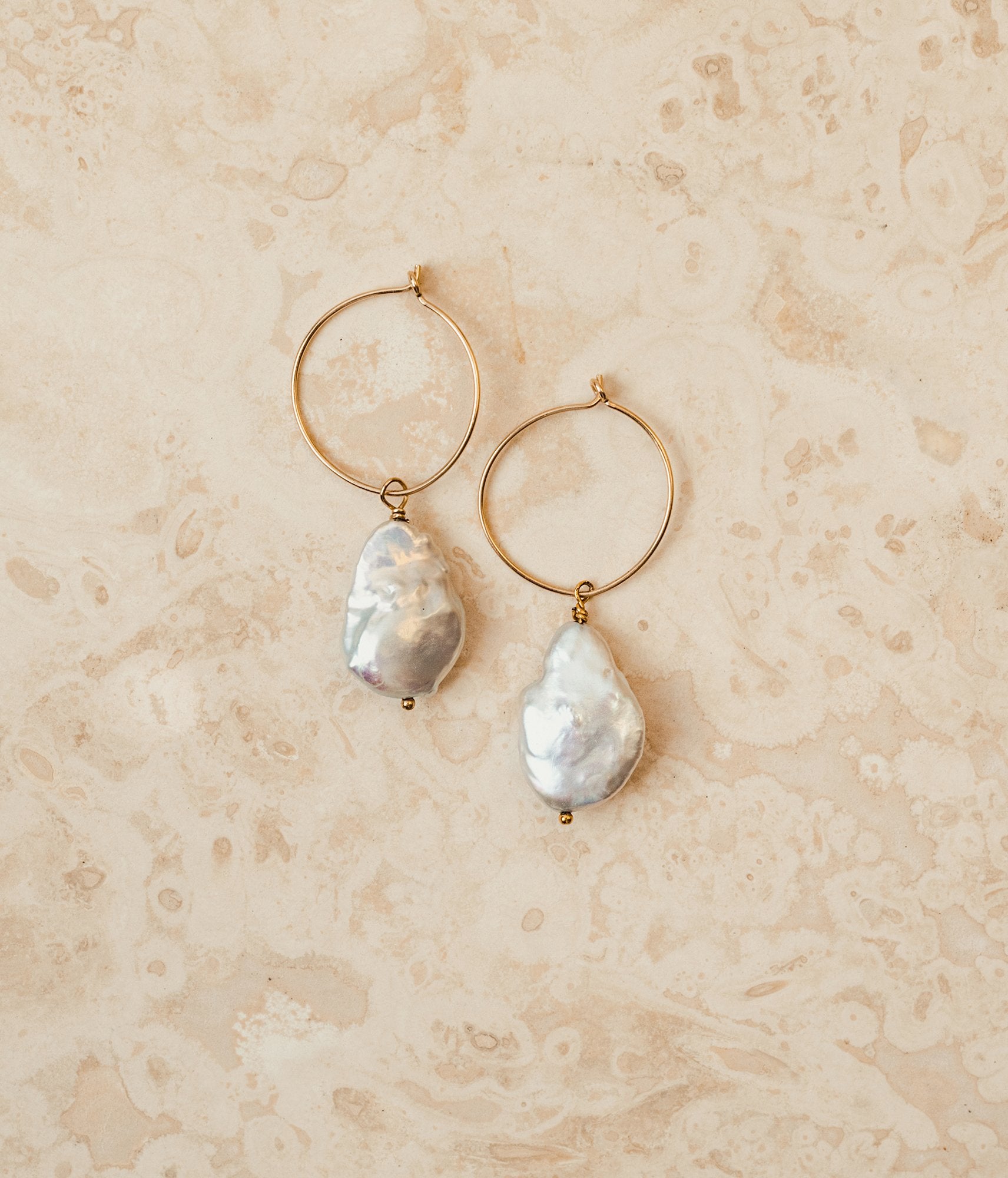 Mother of Pearl Earrings, on marble surface.