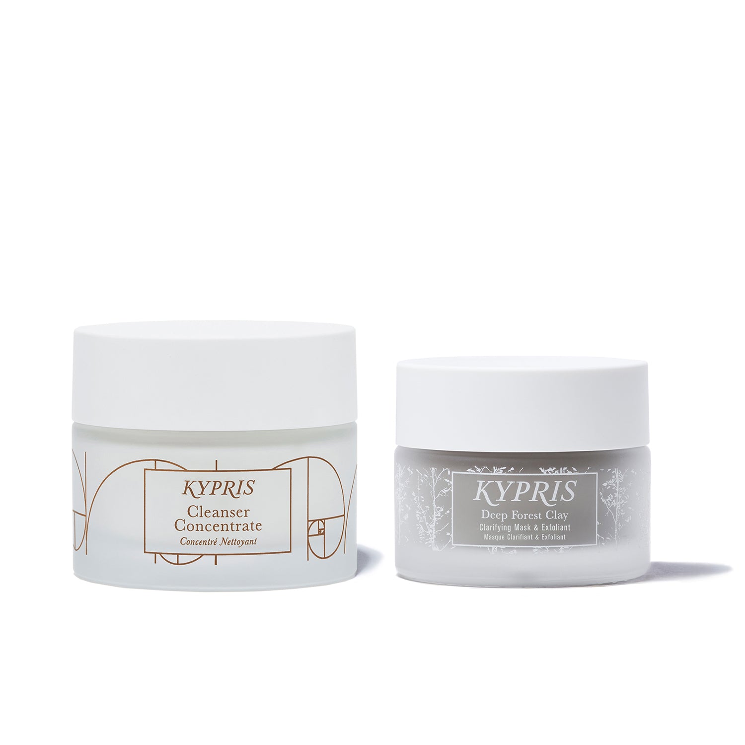 Cleanser Concentrate, in frosted glass jar and Deep Forest Clay Mask, in frosted glass jar, on white background.