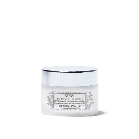 Pot of Shade: Heliotropic SPF 30, in frosted glass jar with white lid, on white background.