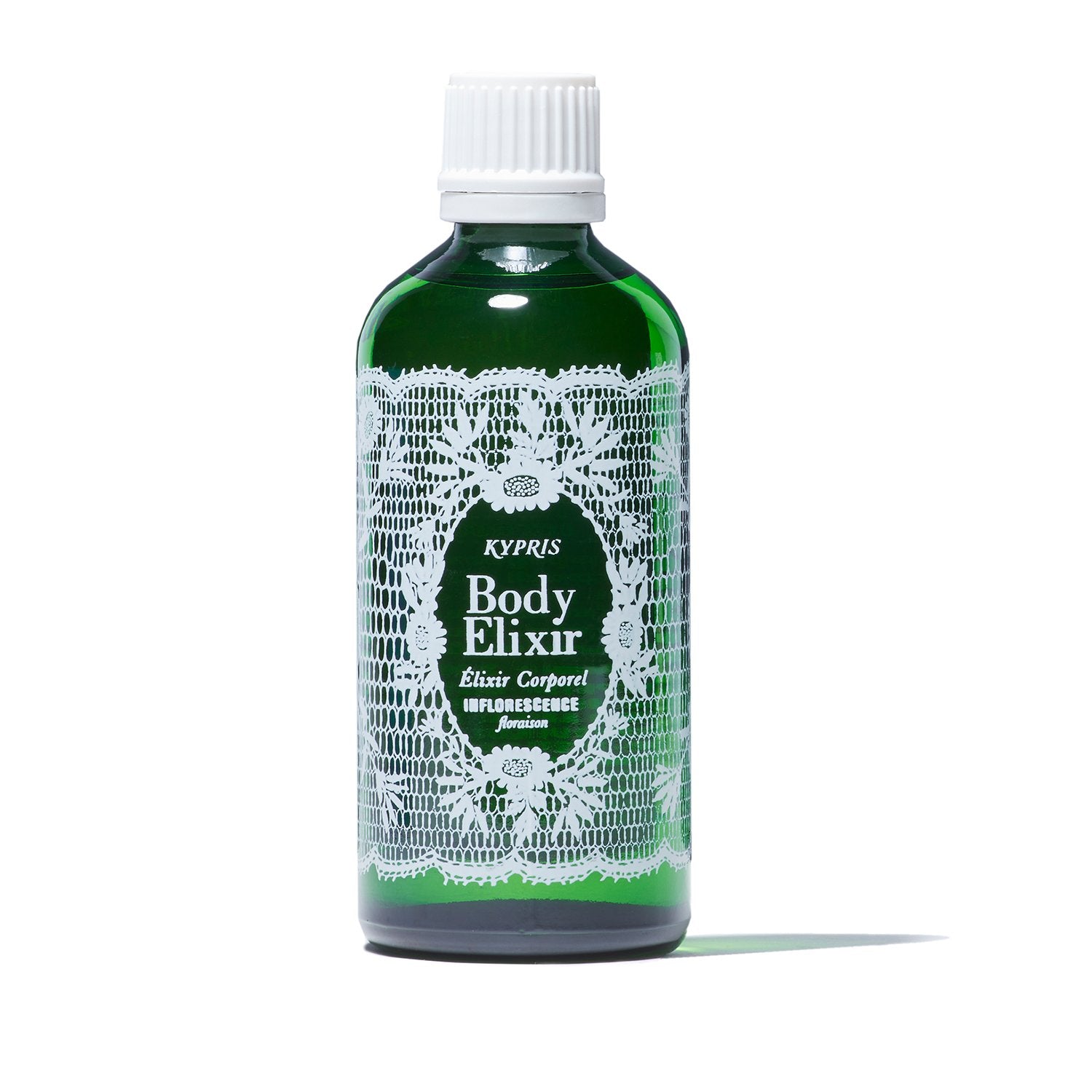 Body Elixir: Inflorescence body oil, in green glass bottle with white cap, on white white background.