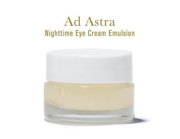 Ad Astra Nighttime Eye Cream Emulsion, rich white creamy texture in clear glass jar with white lid, on white background.